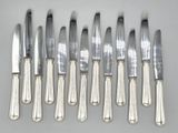 six knives and six knives on a table