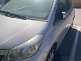 a silver car parked in a parking lot next to other cars