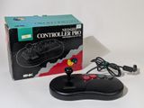 a black controller with a smiley face on it next to a box