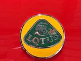 a close up of a badge on a red car