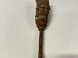 a small metal object that is sitting on a white surface