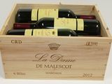 bottles of wine in a wooden box on a white surface