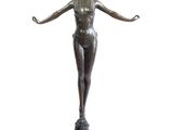 an image of a bronze statue of a woman standing on a pedestal