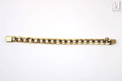 a close up of a gold chain bracelet on a white surface