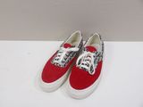 red and white sneakers on a white surface with a white background