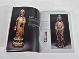 an open book with a picture of a statue of a person and a statue of a person