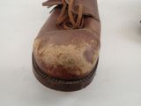 a brown shoe that has been left on the ground