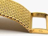 an image of a close up of a gold bracelet with a clasp