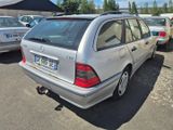 a silver car that is parked in a parking lot