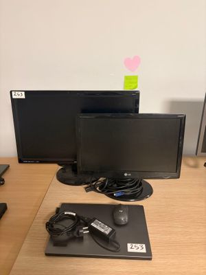 a desk with two monitors, a keyboard, a mouse and a mouse pad on it