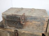 several old wooden boxes stacked on top of each other on a table