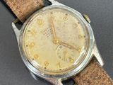 a close up of a wrist watch with a leather strap