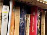 many books that are on a shelf in a book store