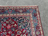 an oriental rug on the ground with a cat laying on top of it