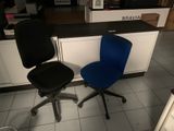 two office chairs sitting next to each other on the floor