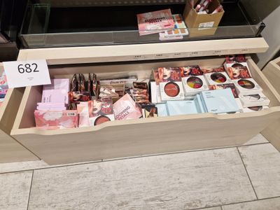 a drawer full of cosmetics and other items in a store
