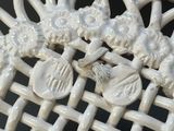 a close up of a white wicker chair with a flower decoration on it