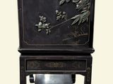 a black cabinet with flowers and birds on it