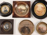 many framed pictures of men and women on the wall