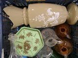 a basket full of vases and other items in it