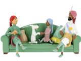 figurines of people sitting on a green couch with a dog