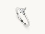 a white gold engagement ring with a pear shaped diamond