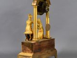 a clock that is sitting on top of a wooden stand