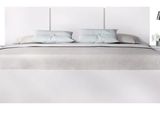 a picture of a bed with a white headboard and night stands