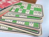 a lot of old bingo cards sitting on a table
