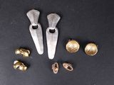 quelques objets en or et en argent sont posés sur une surface noire