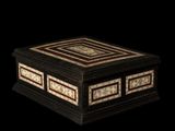 a black and white box sitting on top of a black surface