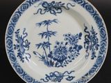 a blue and white plate with a design on it