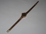 an image of a wrist watch sitting on a white surface