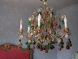 a chandelier hanging from the ceiling in a bedroom