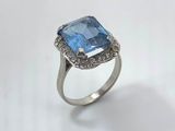 a close up of a ring with a blue stone on it