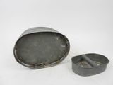 a small tin with a cigarette in it on a white surface
