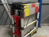 a ladder that is sitting in front of a building