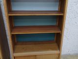 two bookshelves that are next to each other on the floor