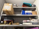 a metal shelf with boxes and other items on it