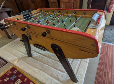 a foosball table in the middle of a living room