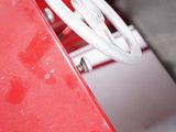 a close up of a steering wheel on a red car