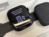 an apple watch sitting on top of a table next to a keyboard