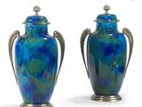 pair of blue vases with silver handles on a white background