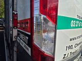rear end of a white truck with a green and white sign on it