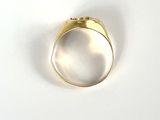 a close up of a gold ring on a white surface
