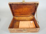 a small wooden box with a book inside of it