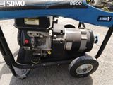 an image of a small generator on wheels in a parking lot