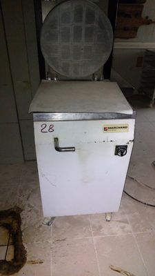 a small white freezer sitting on the floor in a room