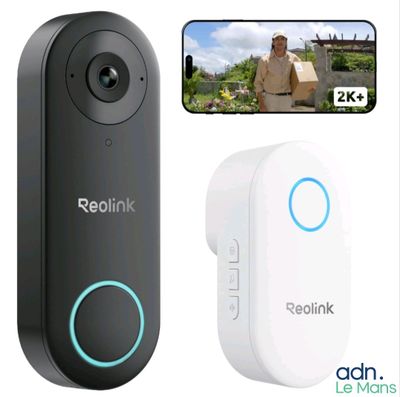 a white and black video camera next to a picture of a man