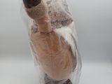 a stuffed animal in a plastic bag on a table